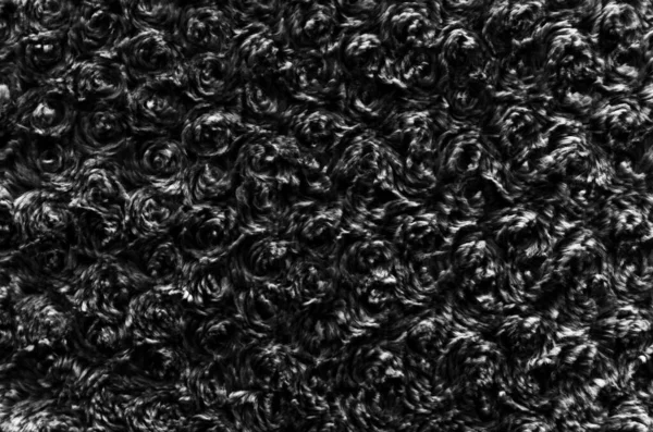 black wool texture background, cotton wool, dark natural sheep wool, black fluffy fur,  fragment grey carpet, close-up gray wool with detail of woven pattern, factory fabric material with a twist