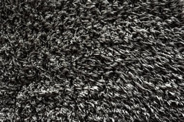 Siyah yün doku arka plan, koyu doğal koyun yünü, gri tüylü kürk dokusu, uzun gri yün halı, koyun derisi.