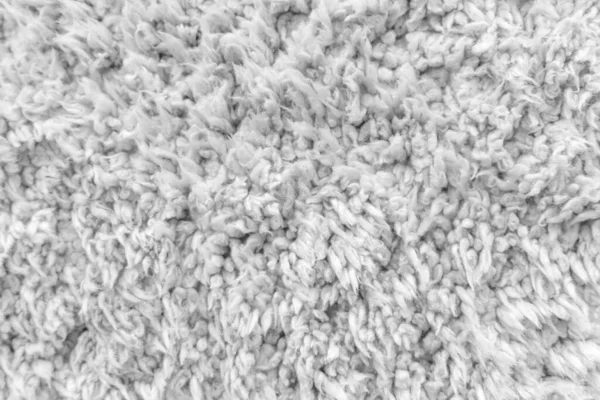 White wool texture background,  light natural sheep wool, texture of white fluffy fur, fragment  wool carpet, gray mat, white rug