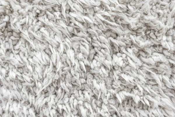 Beyaz yün doku arka plan, hafif doğal koyun yünü, beyaz tüylü kürk dokusu, parça halinde yün halı, gri halı, beyaz halı.