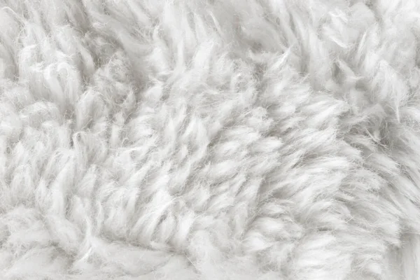 white wool texture background, cotton wool, white fleece, light natural sheep wool, texture of white fluffy fur, white  nappy long wool coat, beige color carpet, close-up macro