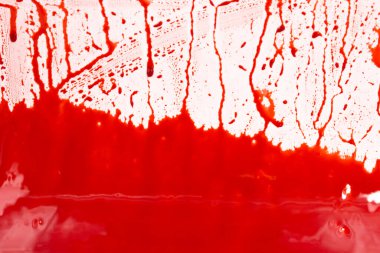 Beyaz arka planda kanlı sıçramalar ve damlalar. Damlayan ve takip eden kırmızı kan (boya)