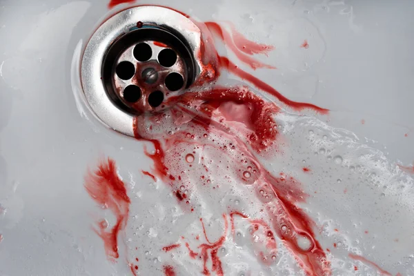 Flowing blood in the sink. Murder concept background