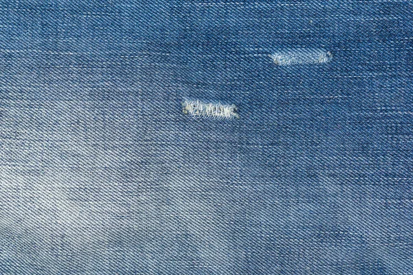 Ripped Blue Jeans Met Een Gat Textuur Achtergrond — Stockfoto
