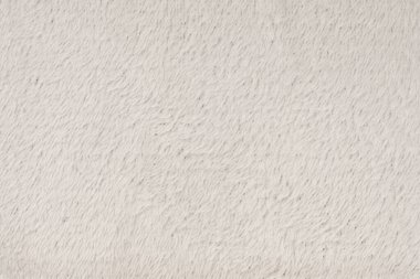 Beyaz desenli beyaz doğal yün. Beyaz, pürüzsüz, yün ekose. Tasarımcılar için tüylü kürk dokusu, yakın plan beyaz yün halı