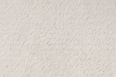 Beyaz desenli beyaz doğal yün. Beyaz, pürüzsüz, yün ekose. Tasarımcılar için tüylü kürk dokusu, yakın plan beyaz yün halı