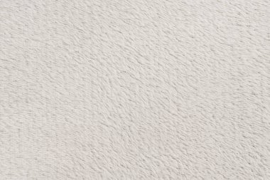 Beyaz desenli beyaz doğal yün. Beyaz, pürüzsüz, yün ekose. Tasarımcılar için tüylü kürk dokusu, yakın plan beyaz yün halı