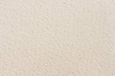 Beyaz desenli beyaz doğal yün. Beyaz, pürüzsüz, yün ekose. Tasarımcılar için tüylü kürk dokusu, yakın plan beyaz yün halı