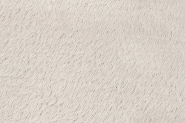 White  natural wool with white texture background. white seamless woolen plaid. texture of fluffy fur for designers, close-up fragment white wool carpet
