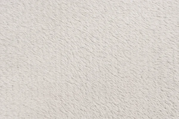 Beyaz desenli beyaz doğal yün. Beyaz, pürüzsüz, yün ekose. Tasarımcılar için tüylü kürk dokusu, yakın plan beyaz yün halı