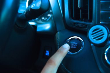 Car engine start stop button of a modern car.  clipart