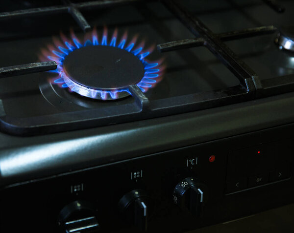 Natural gas burning on kitchen gas stov