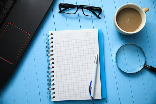 notepad with  notebook and cup of coffee  on tabl