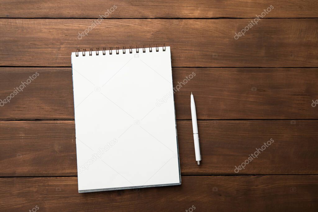 Blank open notebook and pen on  wooden tabl