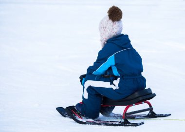 Bebek şarapta kızakta oturuyor.