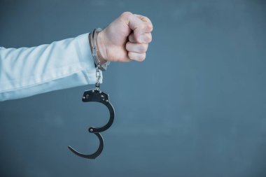 Handcuffs hanging on a Han clipart