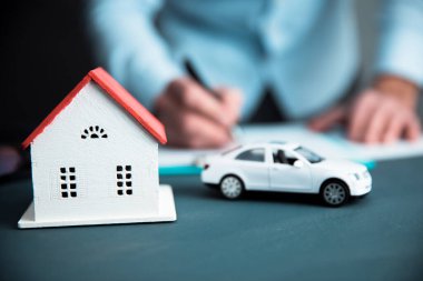 Evi ve arabası olan bir adam.