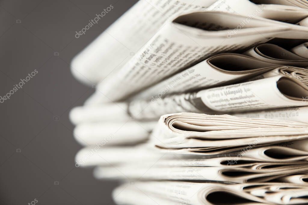 Pile of newspapers on gray background