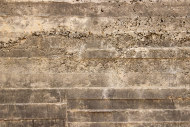 Gri bir duvara oyulmuş bir kaya, düz bir yüzeye