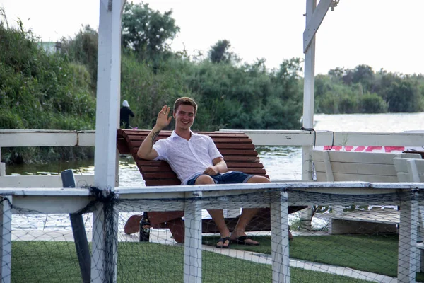 Young Attractive Man White Shirt Sits Floating Restaurant Background Pond — Stock Photo, Image