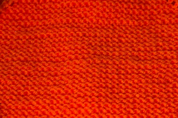 Background orange knitted texture in the form of a diamond