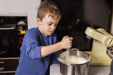 Maddeler ekleyerek Hamur karıştırıcı, cupcakes için çocuk mutfakta kneads