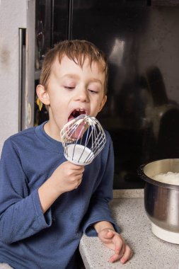 Bir çocuk mutfakta çikolata cupcakes için hamur yoğurma