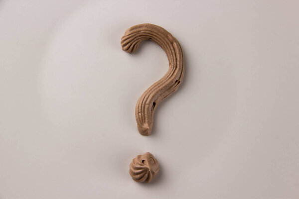 Question mark written with whipped chocolate cream