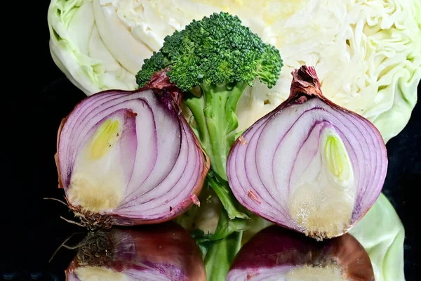 Close up view of fruits and vegetables on black background