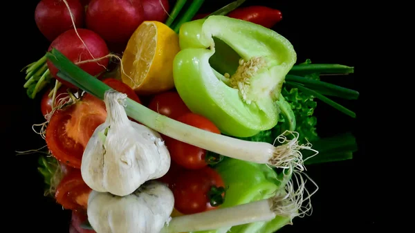 Close up view of fruits and vegetables on black background