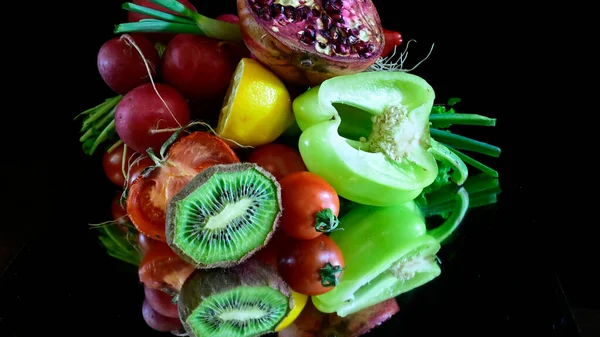 Close up view of fruits and vegetables on black background