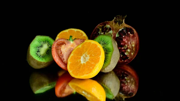 Close up view of fruits and vegetables on black background