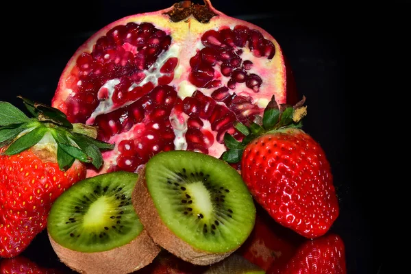 Siyah zemin üzerinde olgun egzotik meyveler seti, sağlıklı gıda konsepti. 
