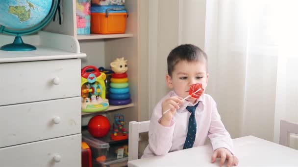 Un bambino mangia caramelle rosso 1920x1080p — Video Stock