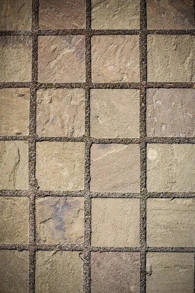 El camino está pavimentado con baldosas de piedra pavimentada.Textura.Fondo . — Foto de Stock