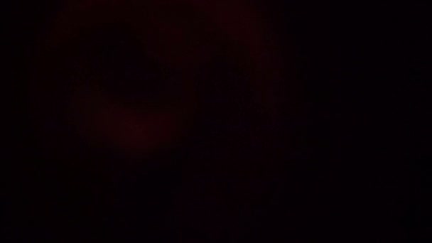 Flackerndes rotes Licht auf schwarzem Hintergrund 4k — Stockvideo