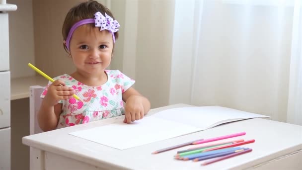 Девочка учится рисовать на клочке бумаги с цветными карандашами HD 1920x1080 — стоковое видео