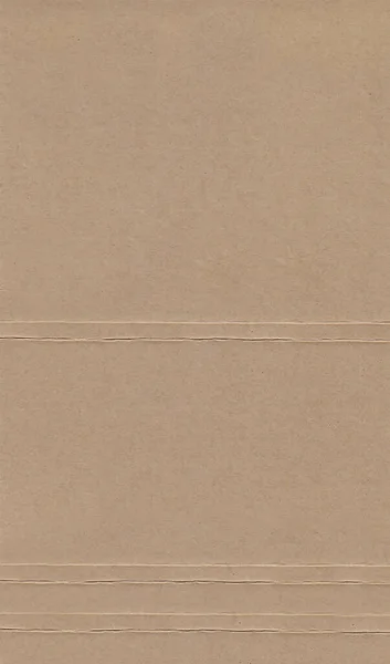 Pressed brown cardboard with a texture on the surface — Stock Photo, Image