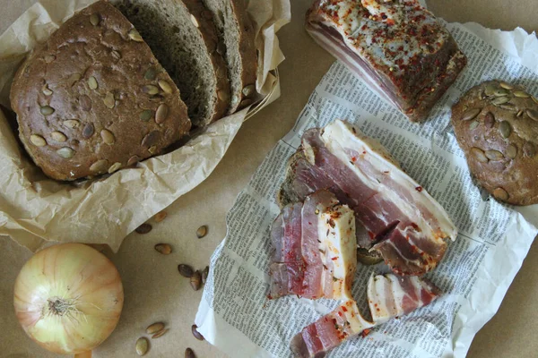 On the newspaper are pieces of sliced fat with a layer — Stock Image On the newspaper are pieces of sliced fat with a layer Royalty Free Stock Photos