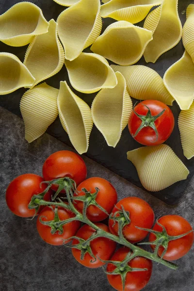 Prpasta conchiglioni. The product of the test. background image.Preparation of pasta with tomato and spices. Cooking.