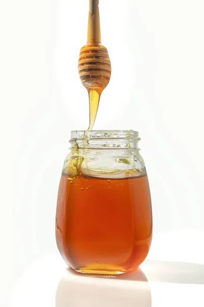 Bee honey with a wooden spoon for honey.isolated objects on white background — Stock Photo, Image