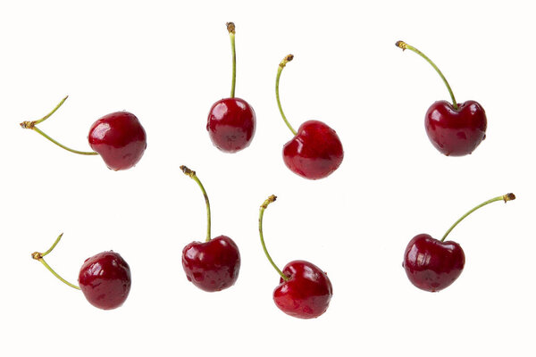 cherry berries isolated on a white background in a chaotic manner .