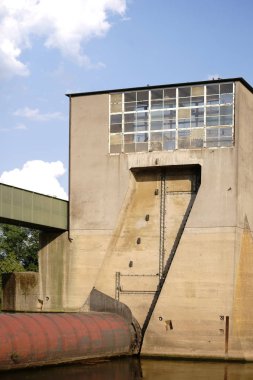 Weir / kapalı bir nehir kilit ile uyuyan nehir su ve endüstriyel binalar.                           