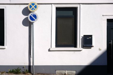 Yol işaret gölgeler ev duvar atmalarını / bir yol işaret bir parlak ev duvar bir posta kutusu ile soyut bir gölge atar