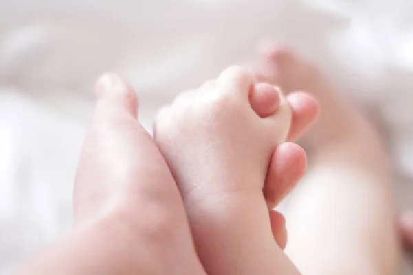 Child Hand Holds Finger Adult — стоковое фото