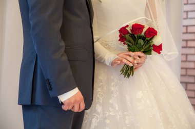 Gelin ve damat, kırmızı ve beyaz gül bir gelin buketi Gelin tutuyor