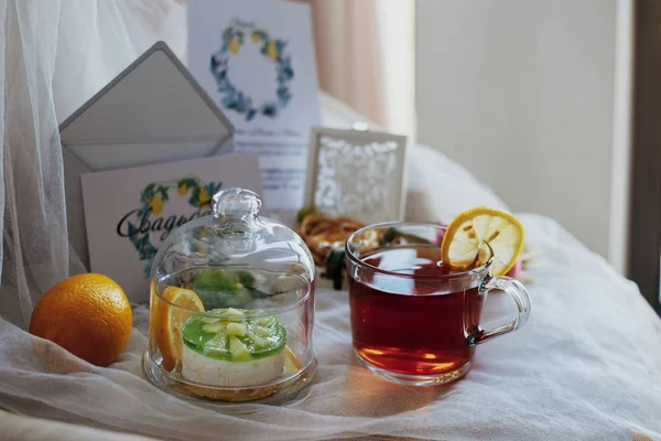 morning, tea with lemon, cake under a glass lid, lemon, wedding invitation