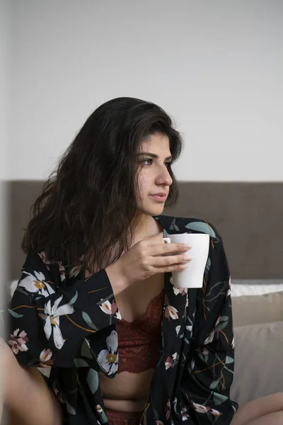Girl drinking coffee in bed