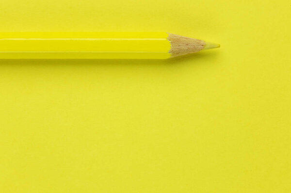 One yellow pencil on a yellow background ,beautiful monochromatic effect