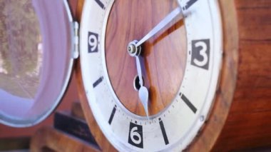 Tahta eski bir saati kuruyor, saati erkek eli ile kuruyor, koruyucu kapağı açıyor ve anahtarı ön plana takıyor, bir dakika ve bir saat boyunca.